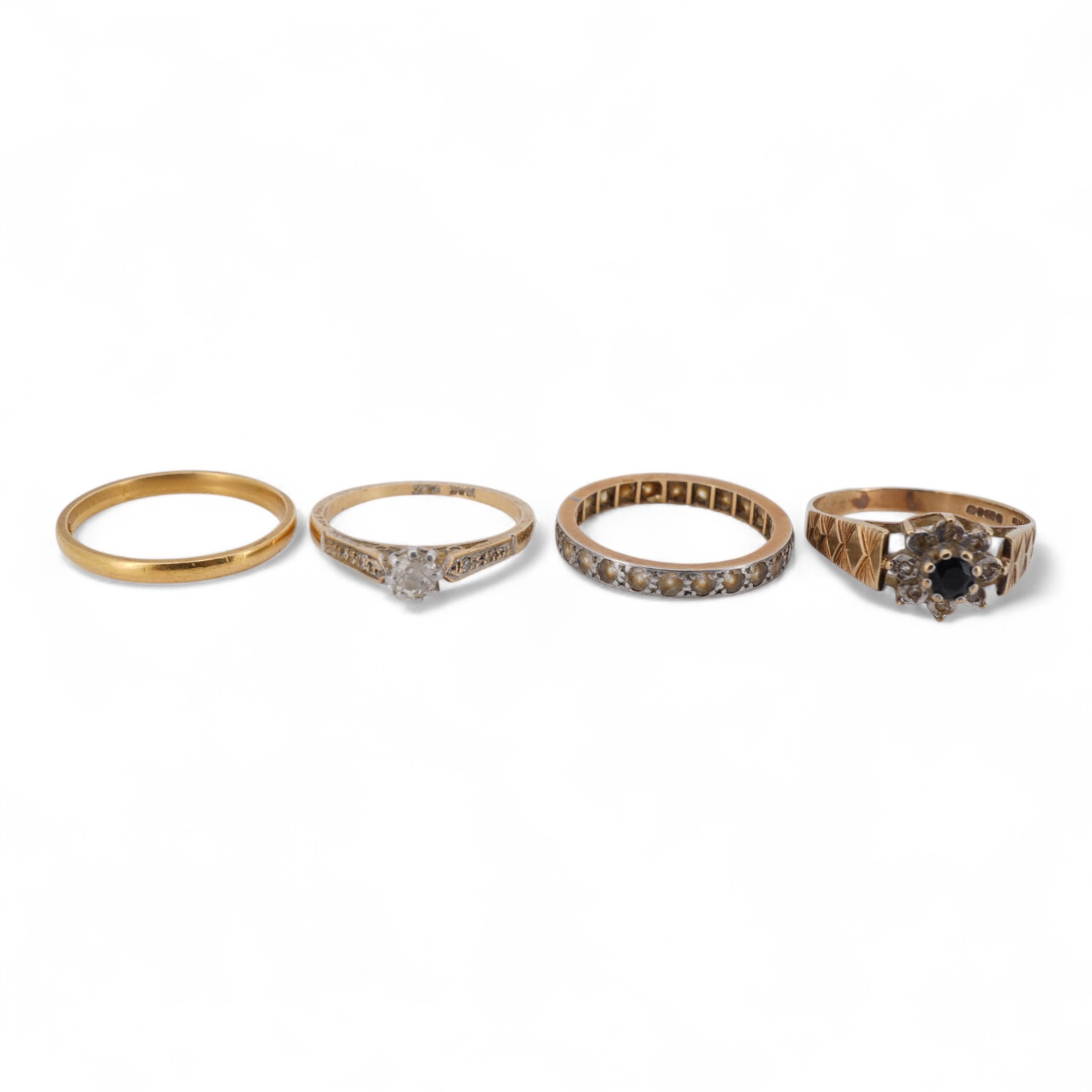 A 22ct wedding band, size M, 2 grams, an 18ct, plat and single stone diamond ring, a a modern 9ct gold, sapphire and diamond cluster ring and a yellow metal and white stone, eternity ring.